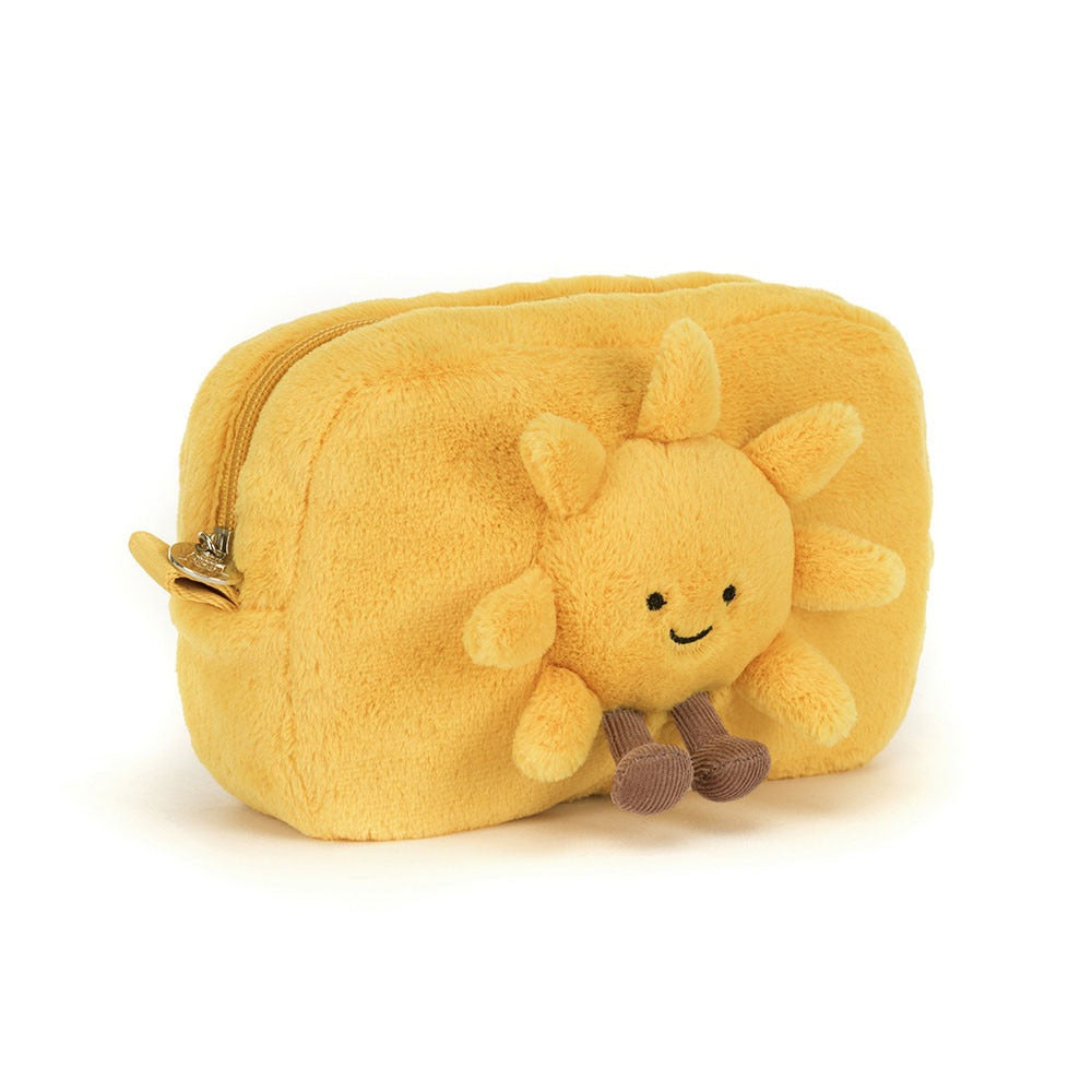 A 45 degree view of a bright yellow plush pouch featuring a smiling sun with soft rays, black eyes, a stitched smile, and dangling brown corduroy feet. The pouch has a zipper on the side and is soft, cheerful, and playful in design.
