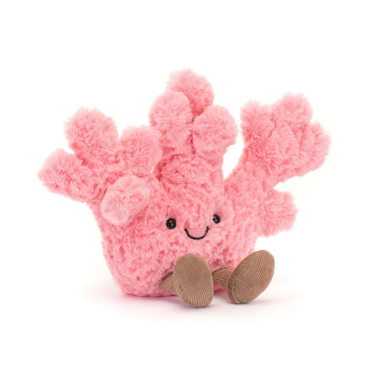 A front view of a soft pink plush coral toy with textured branches, a happy stitched face, and brown corduroy feet