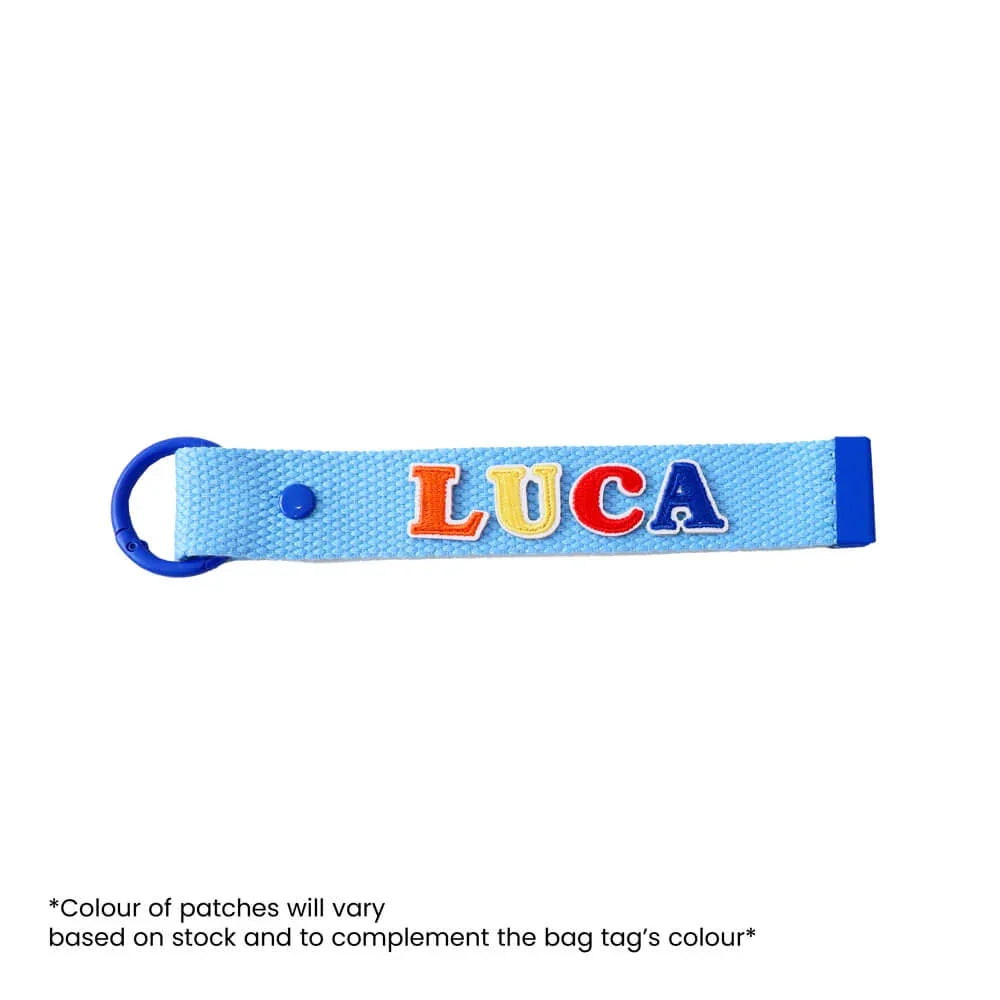 Le Petit Society's customisable blue bag tag with name patches.