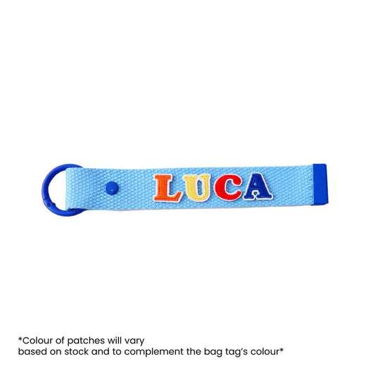 Le Petit Society's customisable blue bag tag with name patches.