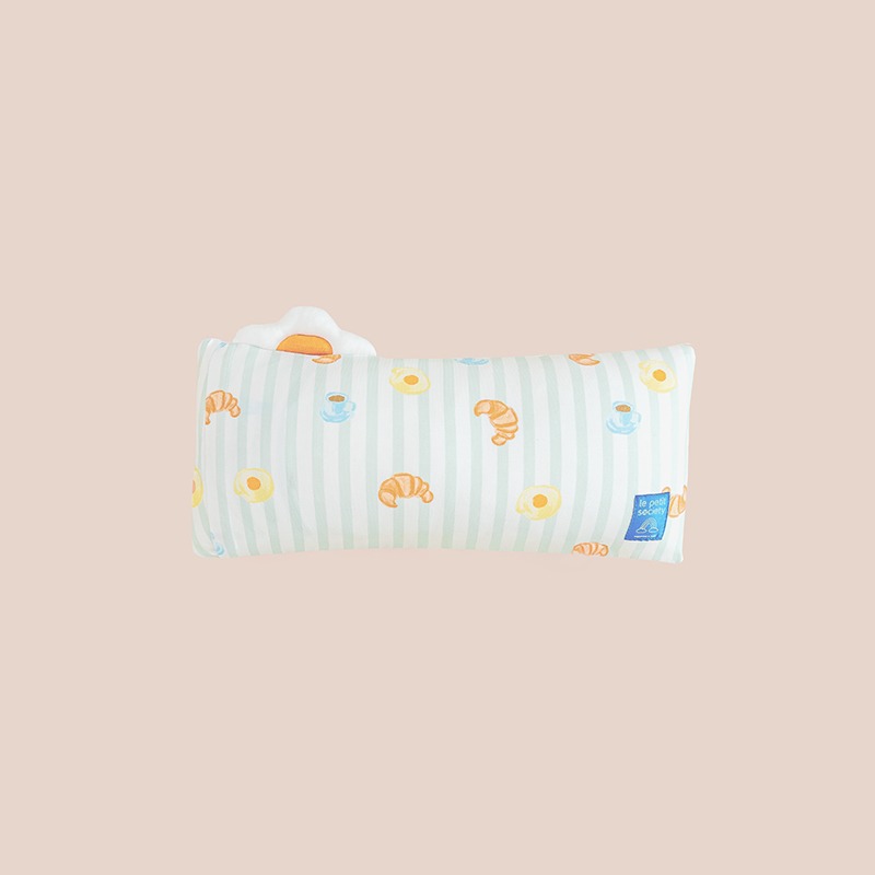 The back of a kids' bamboo pillow with green stripes and a print of breakfast food by Le Petit Society.