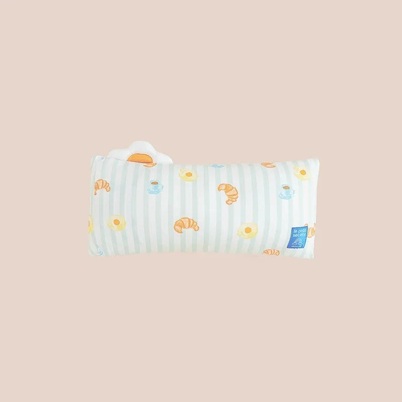 The back of a kids' bamboo pillow with green stripes and a print of breakfast food by Le Petit Society.