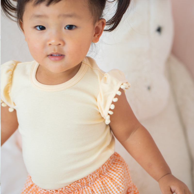 Resort Series - Girls Top with Pom Pom Sleeves in Peach by Le Petit Society — image 3