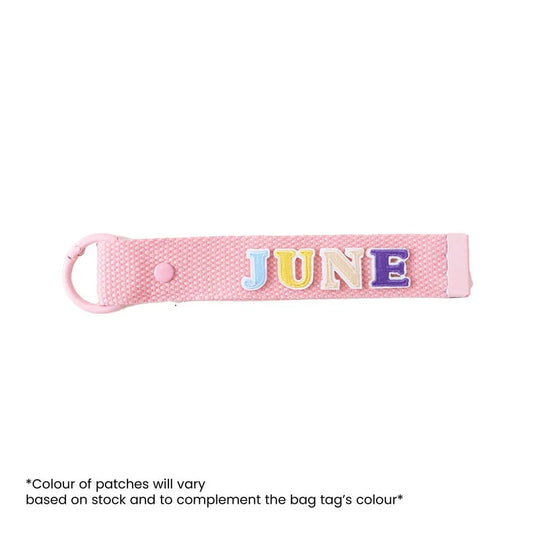 Le Petit Society's customisable pink bag tag with name patches.