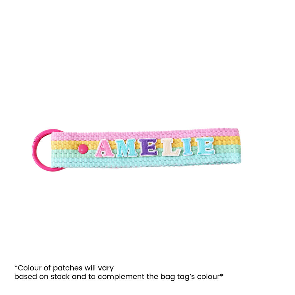 A rainbow-coloured bag tag customised with name patches from Le Petit Society.