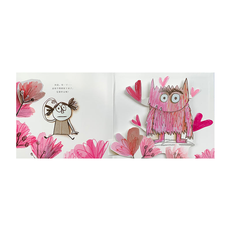 Pop-up book on grass showing a worried girl with pigtails on the left, surrounded by pink flowers. On the right, a pink furry monster with hearts around it stands, smiling with wide eyes and raised arms. Text appears above the girl.