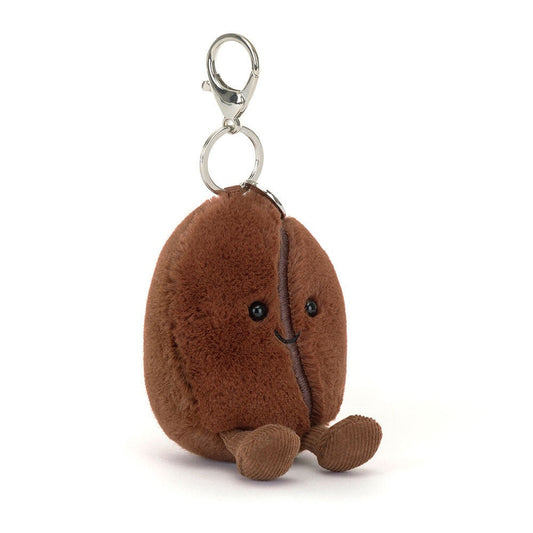 A 45 degree view of a cute plush coffee bean keychain with smiling face, soft brown fabric, black eyes, and dangling feet, attached to a silver metal clip‚Äîperfect for bags, keys, or gifts.
