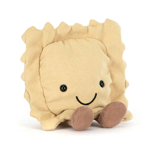 A front view of a soft plush toy shaped like a smiling beige ravioli with black bead eyes and brown corduroy legs.