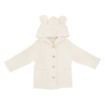 A baby boy cardigan in cream waffle jersey from Le Petit Society. It comes with buttons down the front, double front pockets and a hood with bear ears.