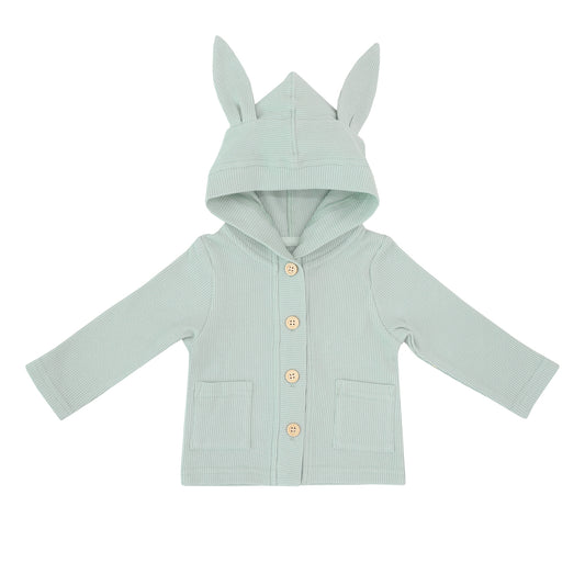 A sage green baby cardigan from Le Petit Society. Made with waffle jersey fabric, it also comes with bunny ears on the hood and two front pockets.