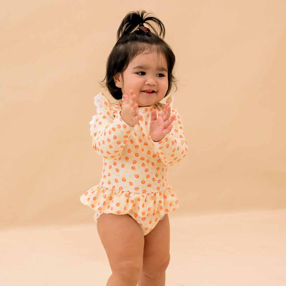 Baby Ruffle Swimsuit in Peach Print by Le Petit Society — image 2