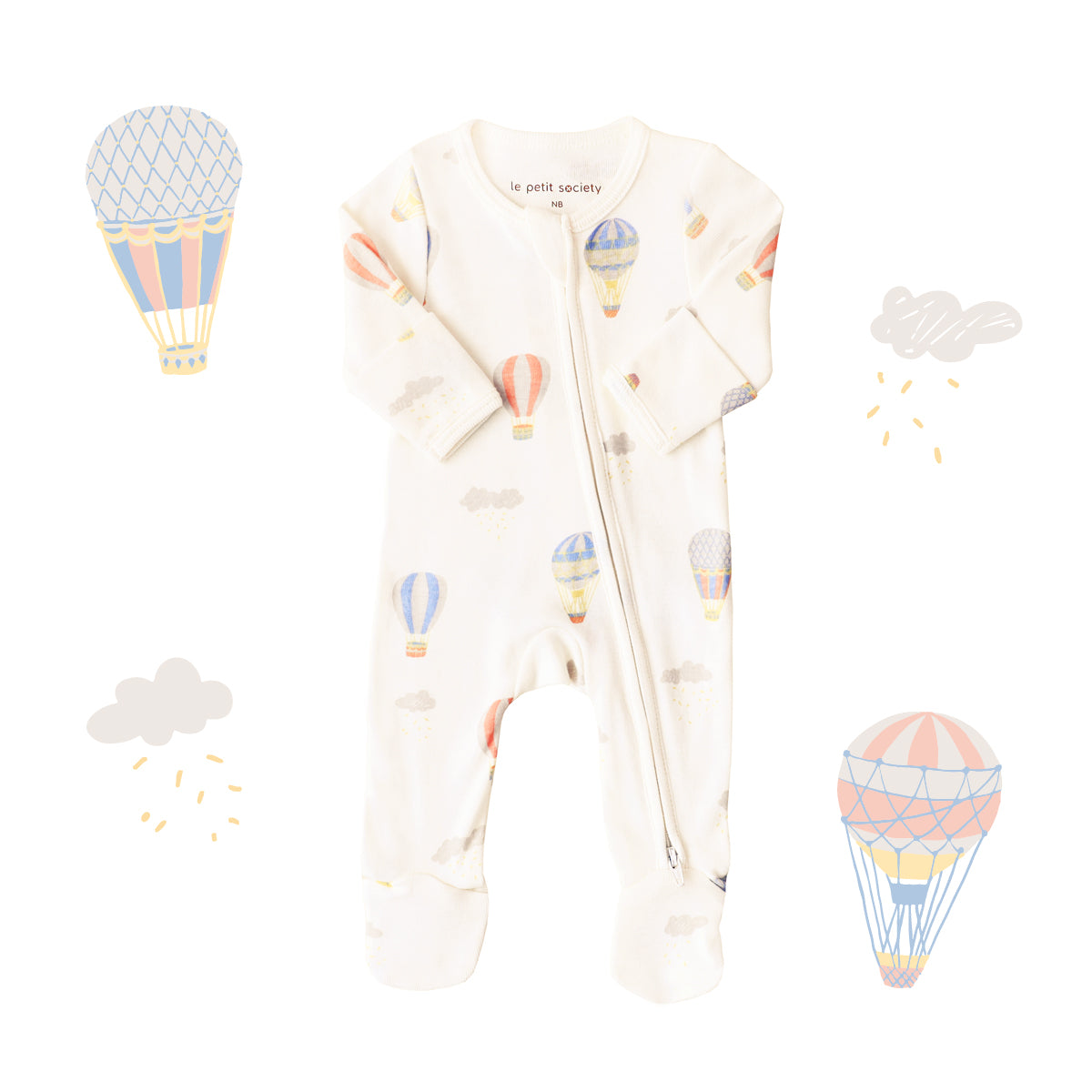 An organic baby zip sleepsuit from Le Petit Society. It is beige in colour with a print of hot air balloons and foldable mittens and footies.