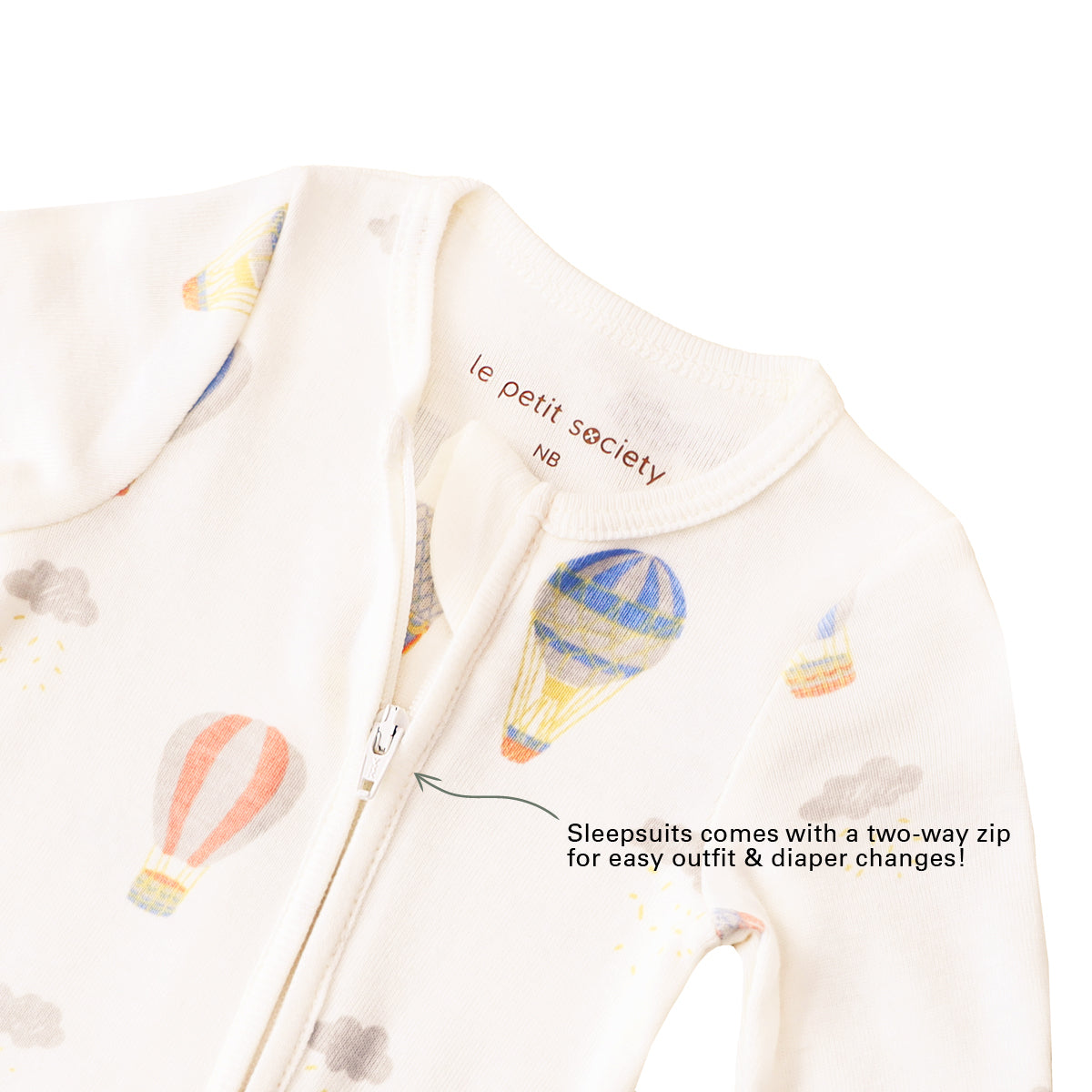 An infographic demonstrating the two-way zipper of a baby zip sleepsuit in hot air balloon print, and its function of providing an easy access to outfit and diaper changes.