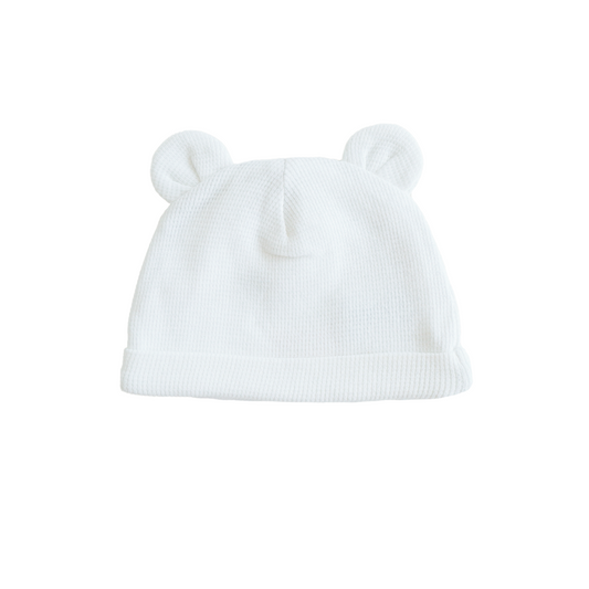 An organic baby bear hat in white by Le Petit Society.
