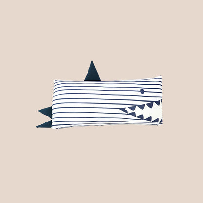 A bamboo pillow in a navy shark design for kids by Le Petit Society.