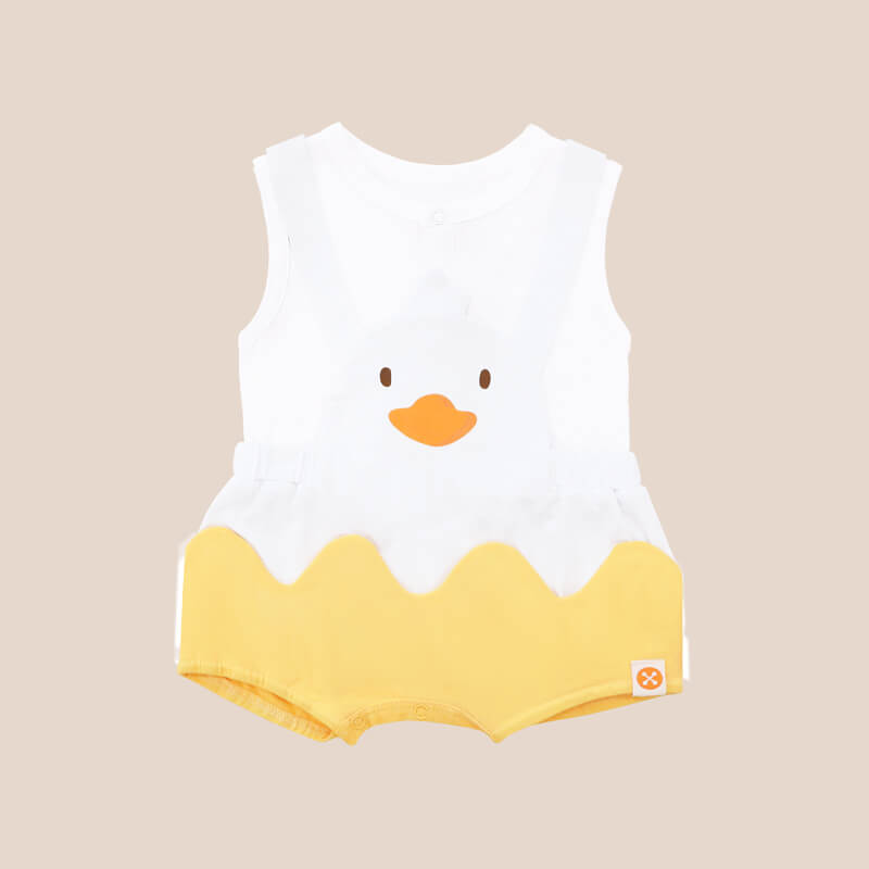 An animal-themed baby romper by Le Petit Society, featuring a duck's face at the front, complete with bright yellow bottoms and white cross back straps over a white base.