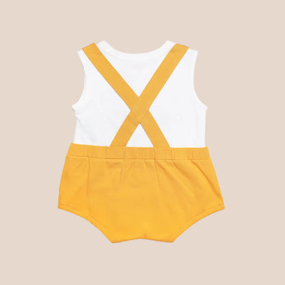 An animal-themed baby romper by Le Petit Society, featuring a lion's face at the front, complete with bottoms and cross back straps in yellow-orange.