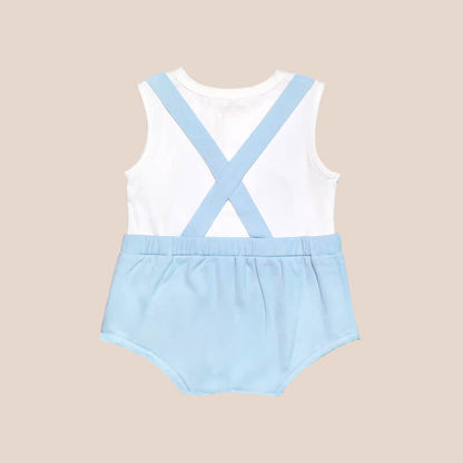 An animal-themed baby romper by Le Petit Society, featuring a blue penguin's face at the front, complete with blue bottoms and blue cross back straps over a white base.