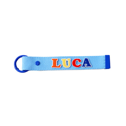 Le Petit Society's blue bag tag customised with name patches.