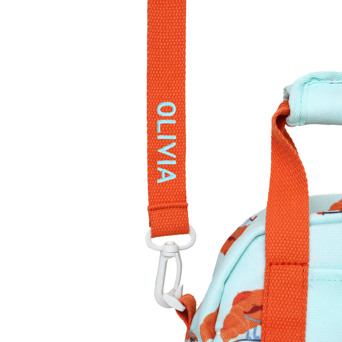 A close-up of a personalised name embroidery on an orange bag strap of a thermal lunch bag from Le Petit Society.
