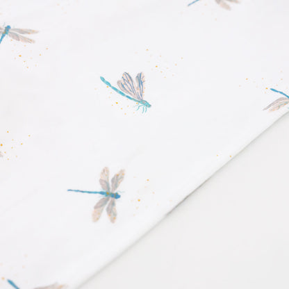 A close-up of the dragonfly print of Le Petit Society's organic zip sleepsuit.