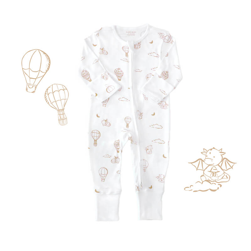 Le Petit Society's organic baby zip sleepsuit in white with a print of dragons, clouds, moons and hot air balloons. It comes foldable mittens and footies.