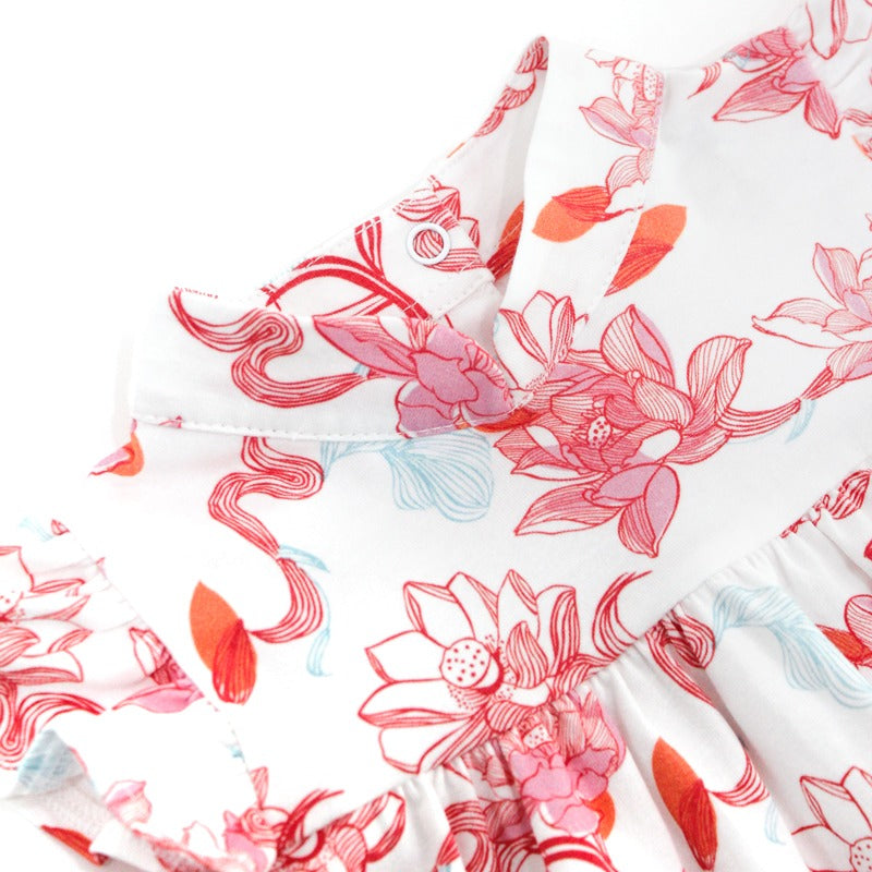 Close-up of the baby girl dress from the Le Petit Society x Sheila Sim CNY 2026 Lotus Collection. The image highlights the soft mandarin collar, gentle gathering at the bodice, and the intricate lotus print in coral, pink and light blue tones. The fabric 