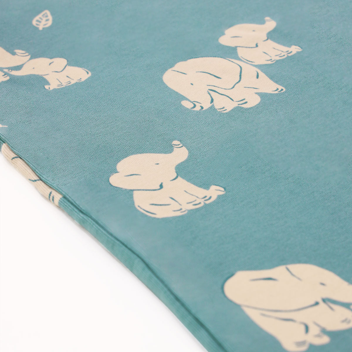 A close-up of the elephant print of Le Petit Society's baby organic zip sleepsuit.