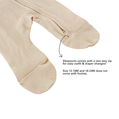 An infographic demonstrating the two-way zipper and lack of footies for size 12-18M and 18-24M of an organic baby sleepsuit in beige by Le Petit Society.