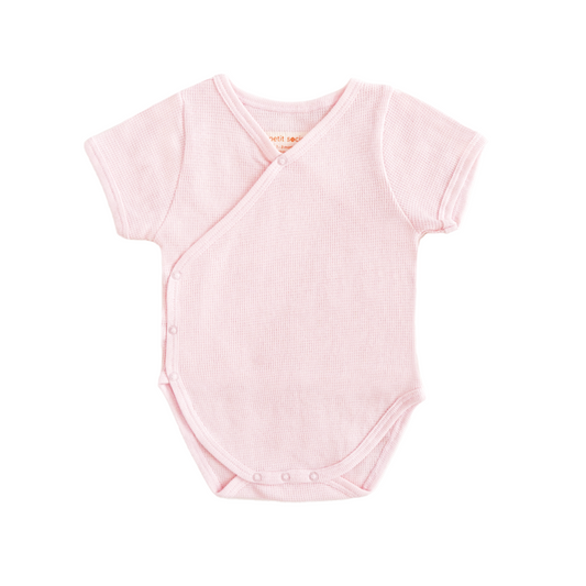 A baby organic kimono romper in pink by Le Petit Society.