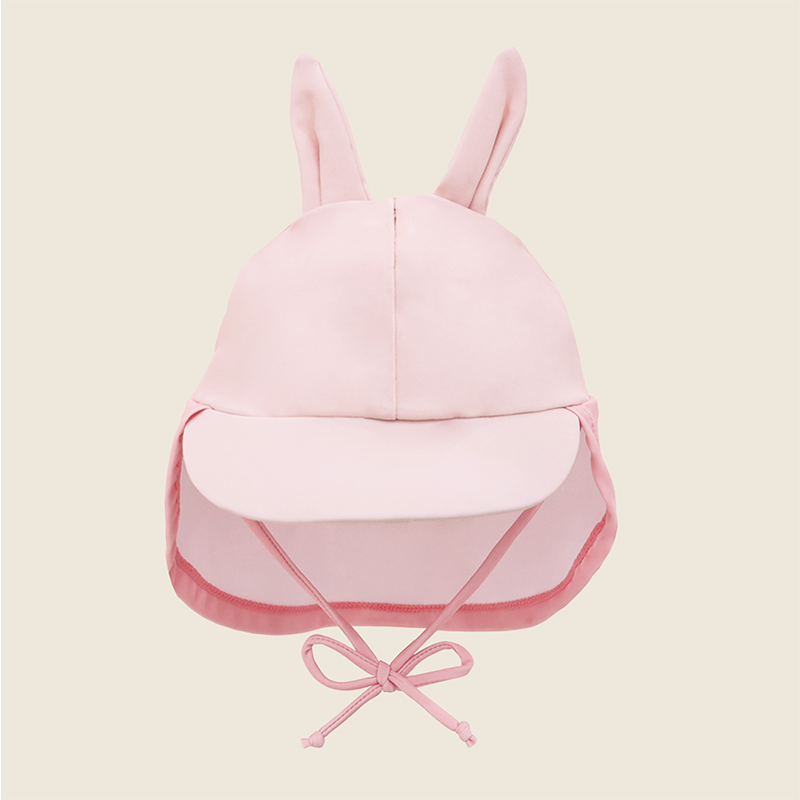 Baby Bunny Sunhat front view with tall bunny ears, pink visor, neck flap and adjustable chin tie in soft pink