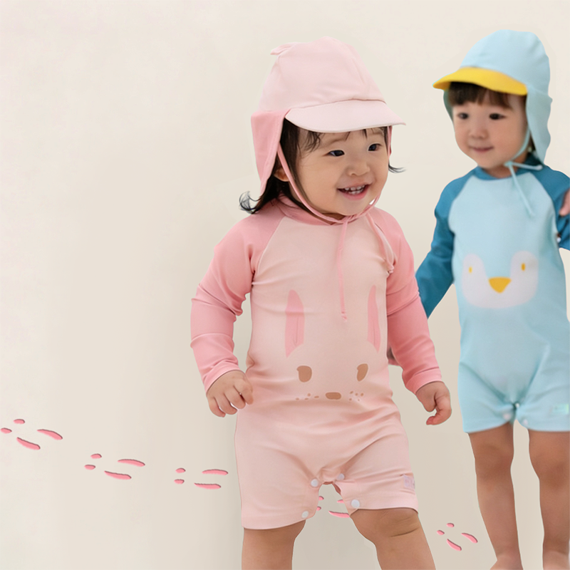 Le Petit Society Baby Bunny Swimsuit Front in Pink with Blue Penguin in the Background