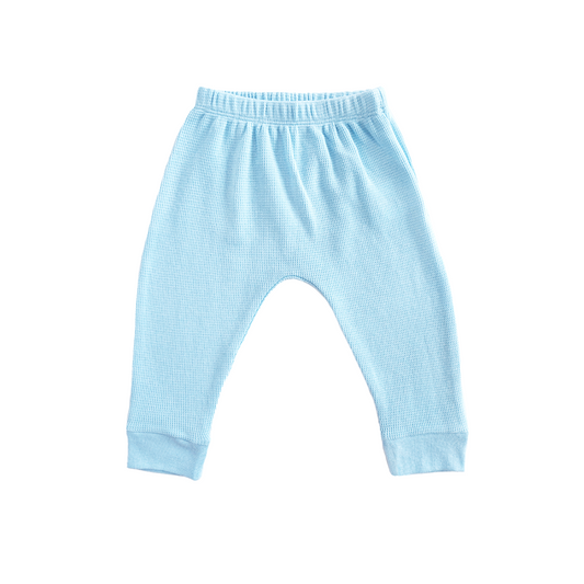 A pair of organic baby leggings in blue by Le Petit Society.
