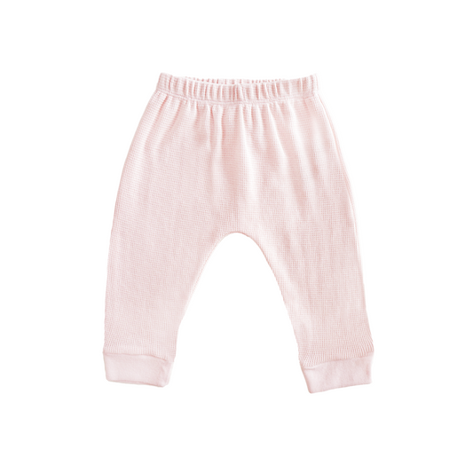 A pair of organic baby leggings in pink by Le Petit Society.

