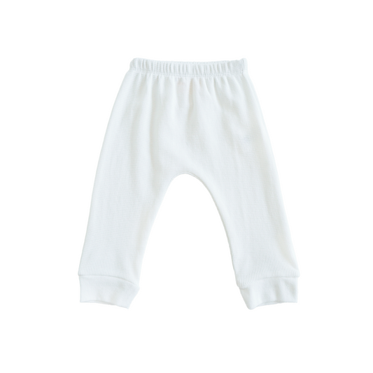 A pair of organic baby leggings in white by Le Petit Society.
