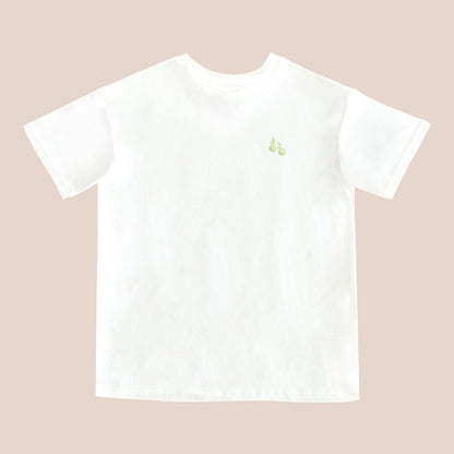 A white adult tee featuring a small print of green pears, from Le Petit Society.