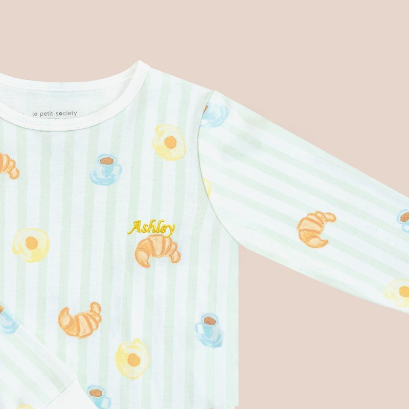 A close-up of a name embroidery personalisation on a kids' sleepsuit by Le Petit Society.