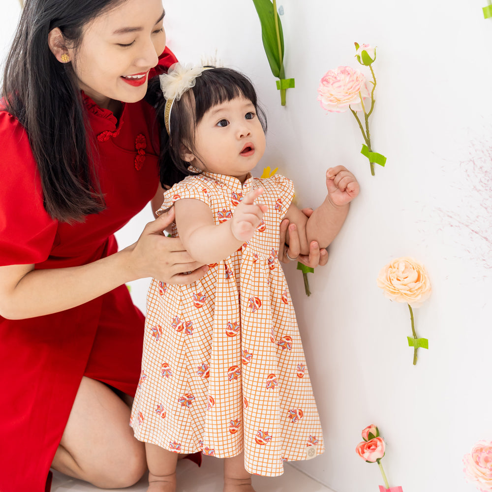 Lion Dance Series - Baby Girl Jersey Dress in Orange Grid Print (Personalisable) by Le Petit Society