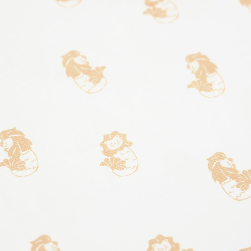 A close-up of an orange Merlion print of a white baby romper from Le Petit Society.