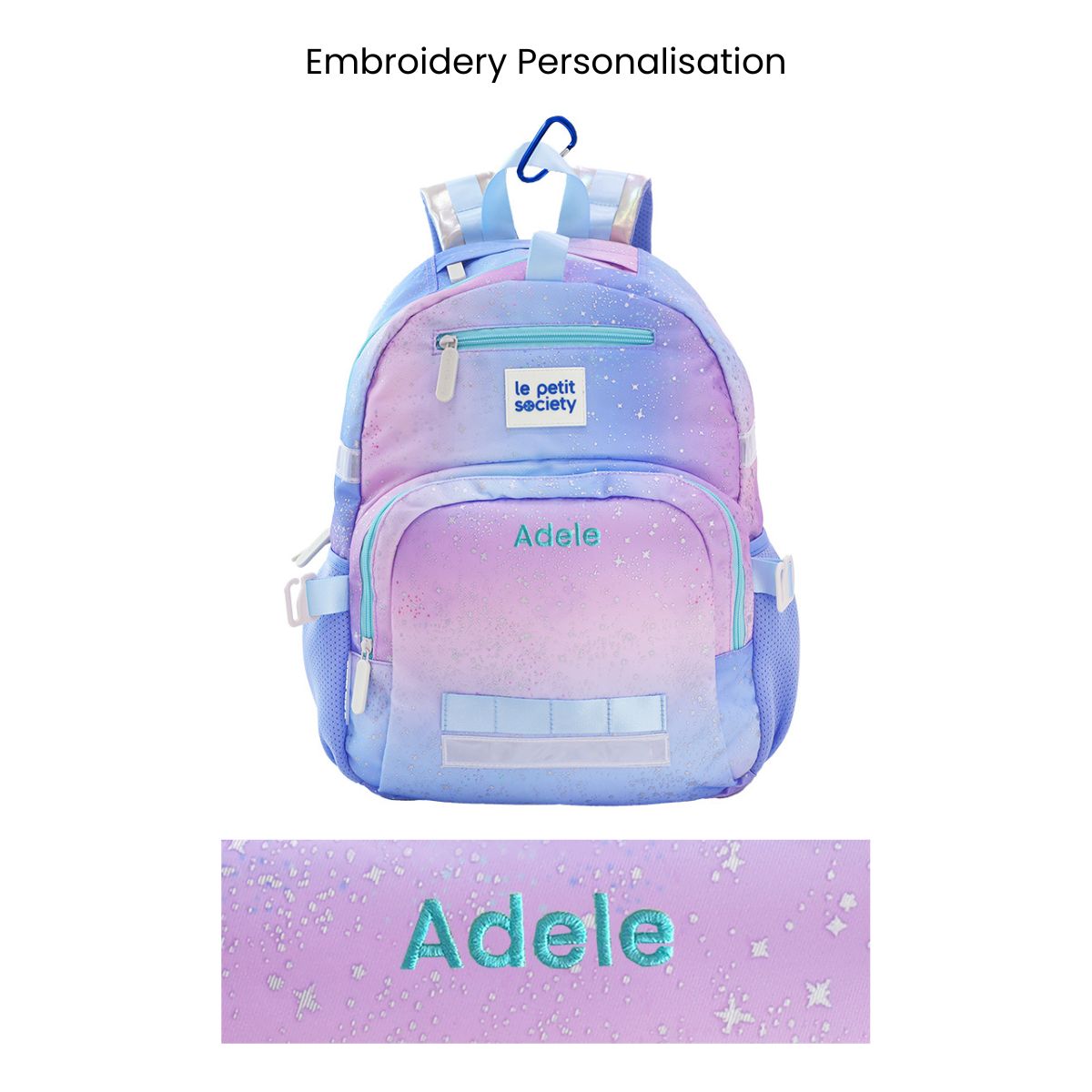 The single pocket kids school bag with an ombre, metallic galaxy design and a personalised name embroidery at the front.