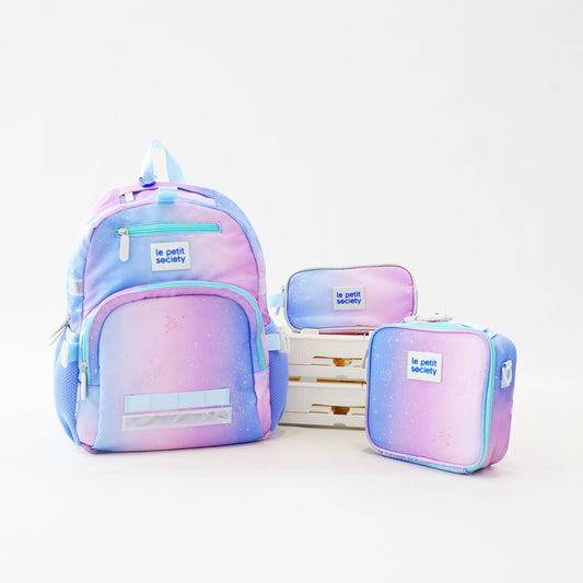 The LPS Kids Essential School Bundle in a purple and blue ombre colour with a planet print. Comes with a school bag, pencil case and lunch bag.