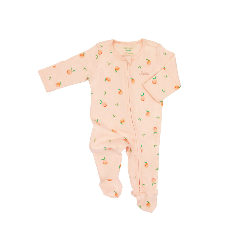 An organic baby zip sleepsuit from Le Petit Society. It is coral pink in colour, with a print of peaches and foldable mittens and footies.