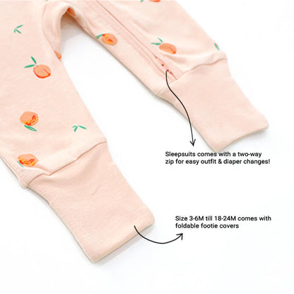 An infographic demonstrating the two-way zipper of a coral pink baby zip sleepsuit, and its function of providing an easy access to outfit and diaper changes.