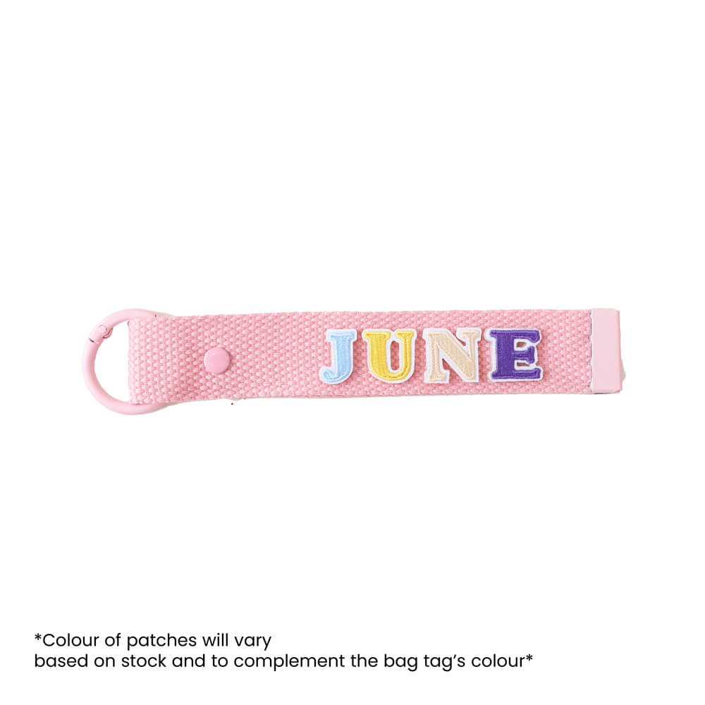 Le Petit Society's customisable pink bag tag with name patches.