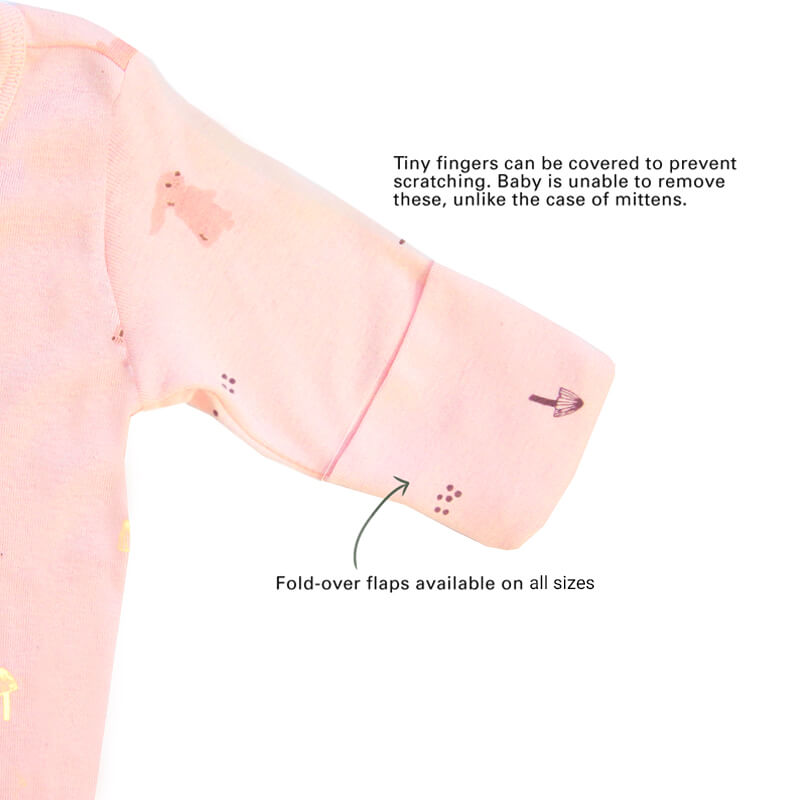 An infographic showing the mittens of an organic baby zip sleepsuit, which come with fold over flaps to cover a baby's hands and keep them warm.