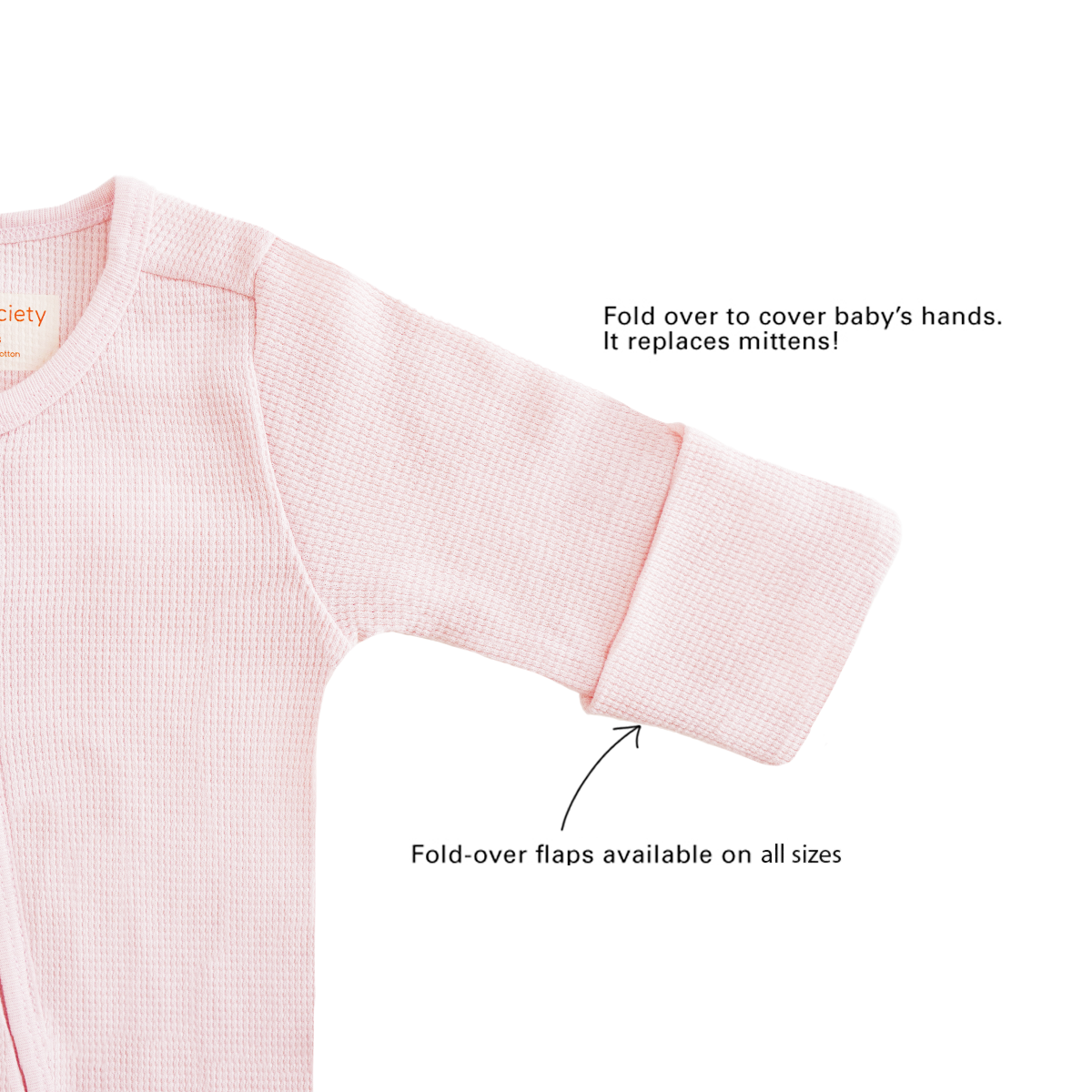 A baby organic zip sleepsuit in pink by Le Petit Society, with fold over flaps at the sleeves to cover a baby's hands, acting as a substitute for mittens.