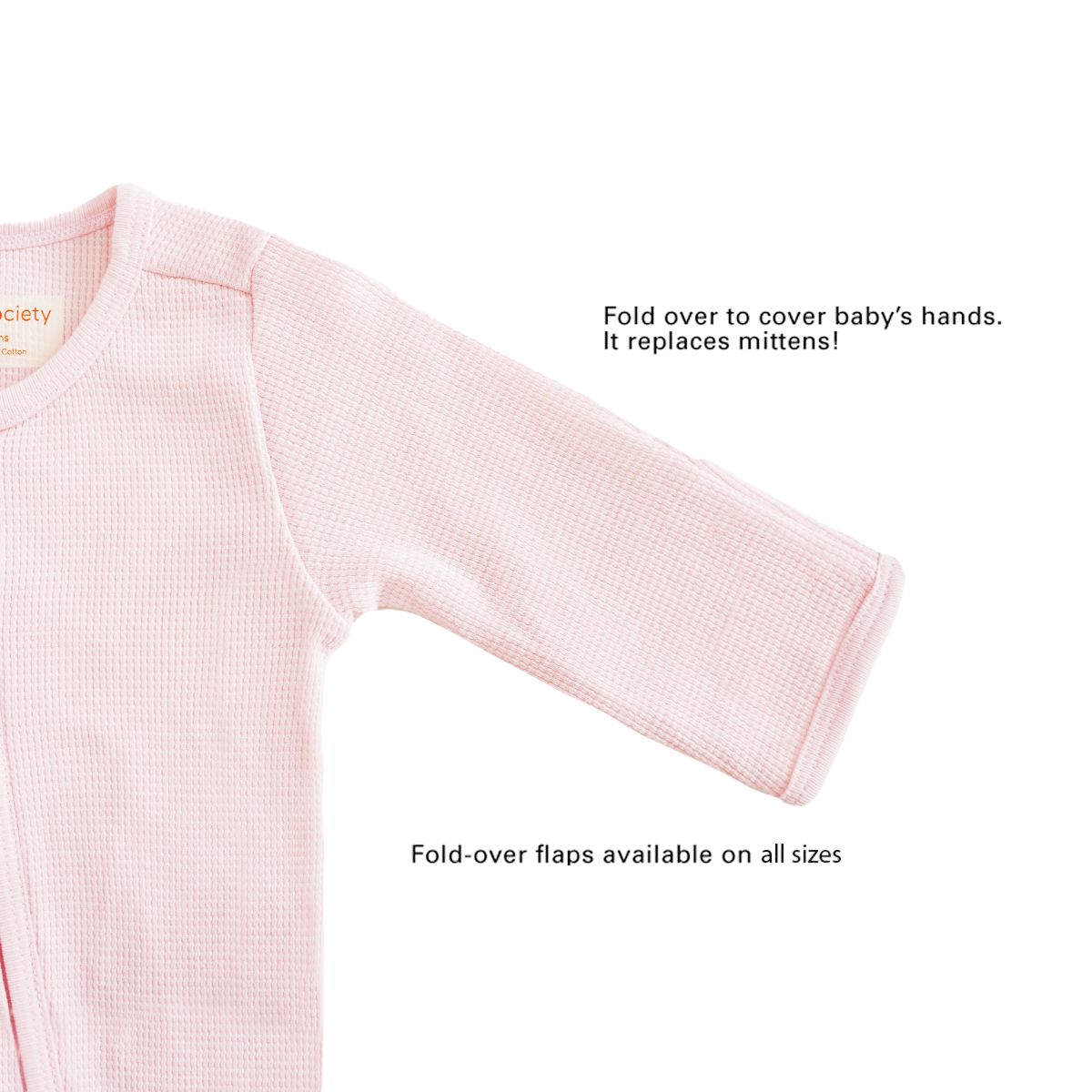 A baby organic zip sleepsuit in pink by Le Petit Society, with fold over flaps at the sleeves to cover a baby's hands, acting as a substitute for mittens.
