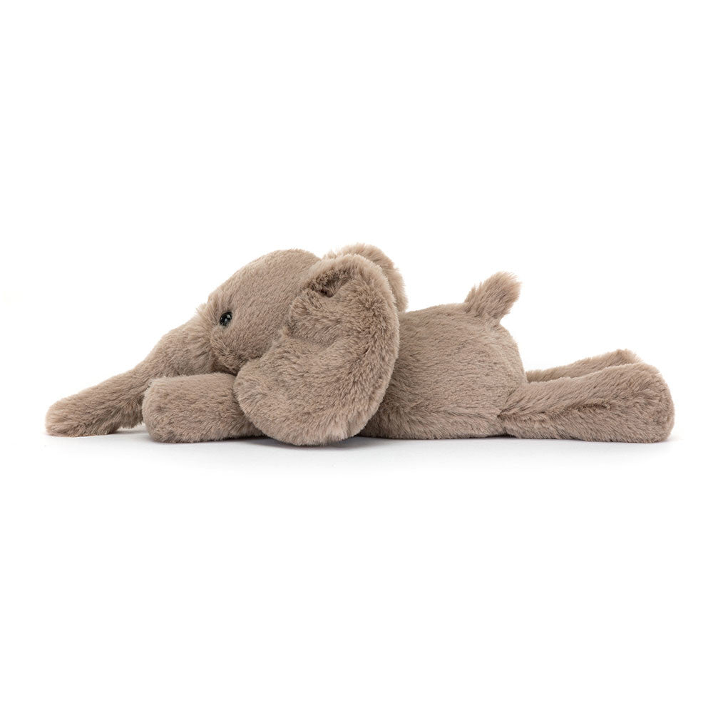 A side view of a tiny soft plush elephant toy in light brown with floppy ears and long trunk. Adorable and huggable stuffed animal, perfect for kids, nursery décor, or as a cuddly gift