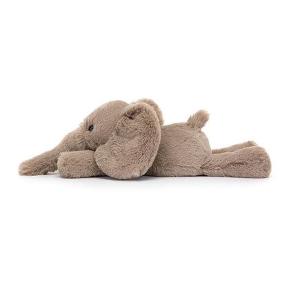 A side view of a tiny soft plush elephant toy in light brown with floppy ears and long trunk. Adorable and huggable stuffed animal, perfect for kids, nursery décor, or as a cuddly gift