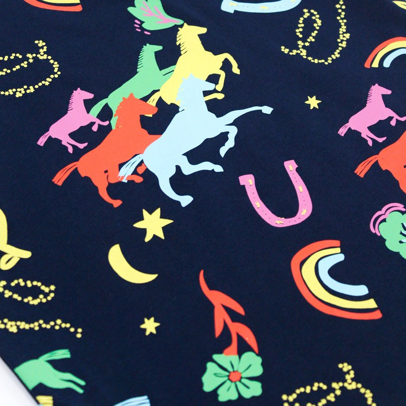 Le Petit Society x Sheila Sim CNY 2026 Rainbow Horse Collection — Close-up shot of the navy fabric showing the detailed rainbow horse print, colourful horseshoes, stars, moons and foliage icons in bright neon tones.